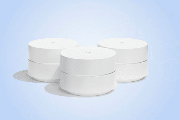 Three white Google Wifi pucks are arranged in a triangular formation against a soft blue background with subtle , light blue hexagonal patterns.