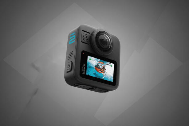 A professional shot of a GoPro Max 2 360- degree action camera, featuring a sleek gray body with blue accents and a screen displaying an action scene . The camera is presented on a modern , professional gray background with subtle geometric patterns.