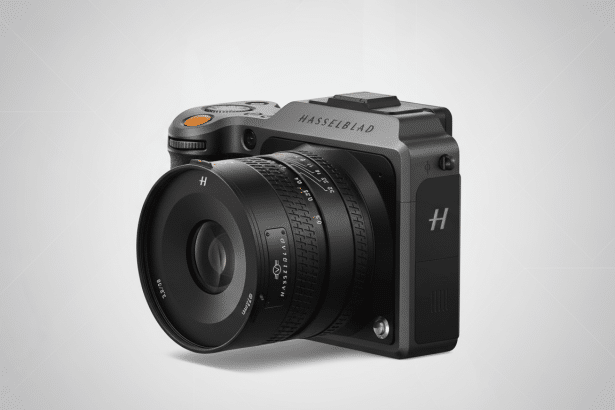 A professional Hassel blad camera with a large lens, presented at a 16 :9 aspect ratio on a subtle gray gradient background with geometric patterns .