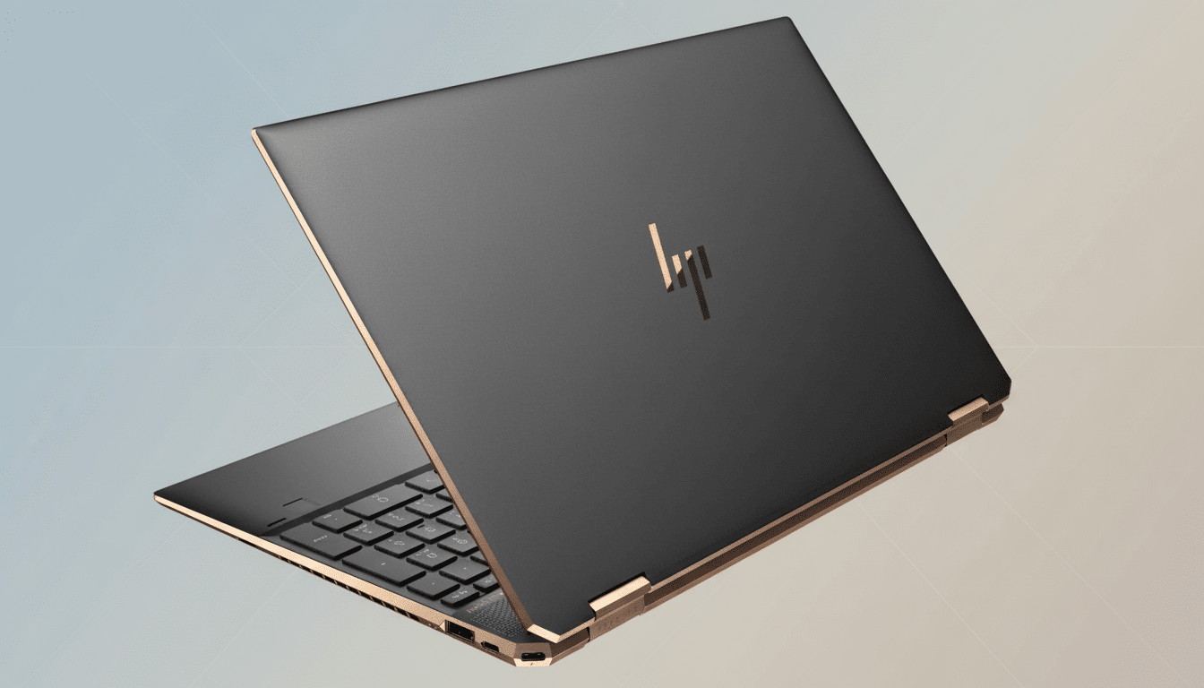 An HP Spectre laptop with a dark gray lid and gold accents, slightly open, on a soft gradient background.