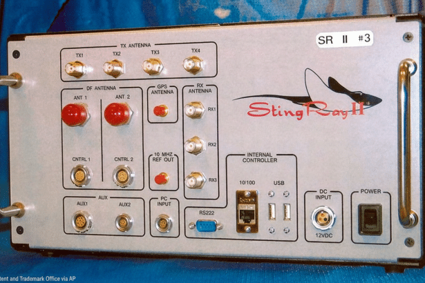 The Sting Ray II radio, a signal intelligence device , has been resized to a 1 6:9 aspect ratio. The front panel features various antenna ports, control inputs, data ports including USB and RS2 32, and a power input , along with the Sting Ray II logo depicting a stylized ray . The original background is maintained .