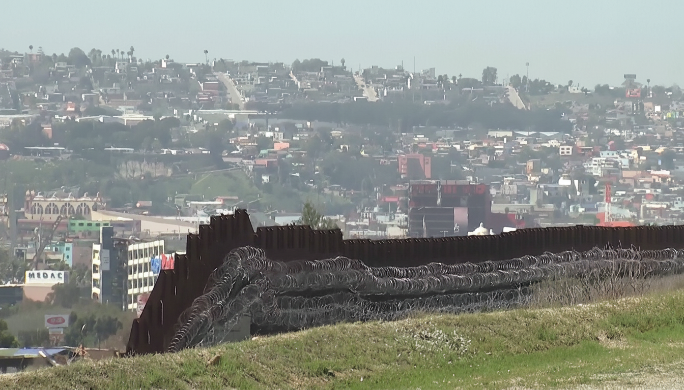 US border agent inspects smartphone at checkpoint amid record phone searches