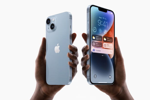 A pair of hands holding two light blue iPhone 1 4 models against a clean white background. One phone shows its back with the Apple logo, while the oth