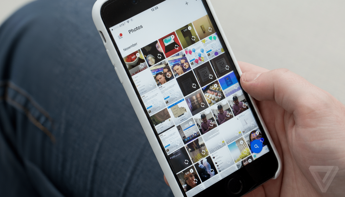 A person's hand holding a white - cased iPhone displaying a photo gallery.