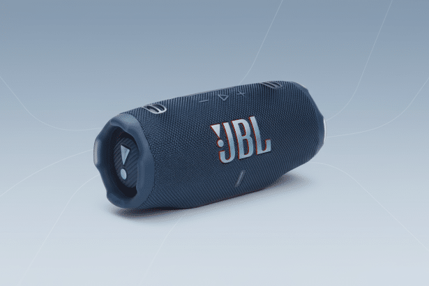 A blue JBL portable speaker rendered with a soft, gradient background and subtle geometric patterns.