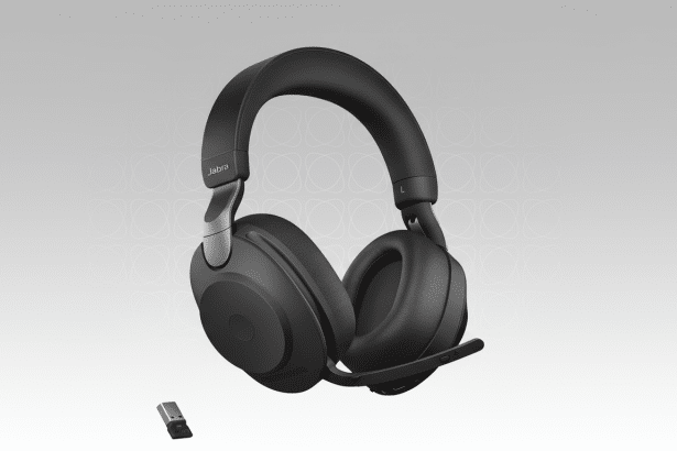 Black Jab ra E volve2 6 5 Flex headphones with a small USB dong le, presented against a professional light grey gradient background with subtle circular patterns .