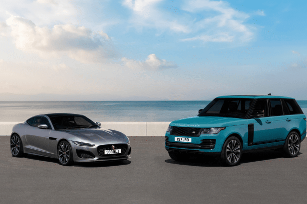 A silver Jaguar F-Type and a teal Range Rover parked side-by- side on asphalt , with an ocean and sky background .