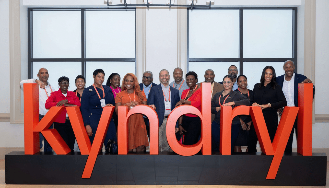 A group of professionals standing behind a large orange Kynd ryl  sign.