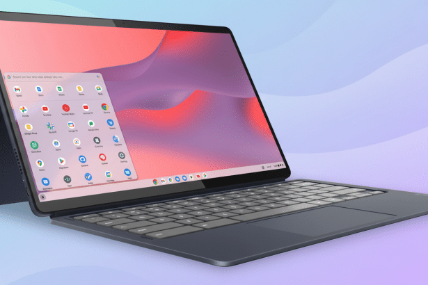 A professional image of a dark blue convertible laptop with a detachable keyboard, displaying a colorful user interface with various app icons, set ag