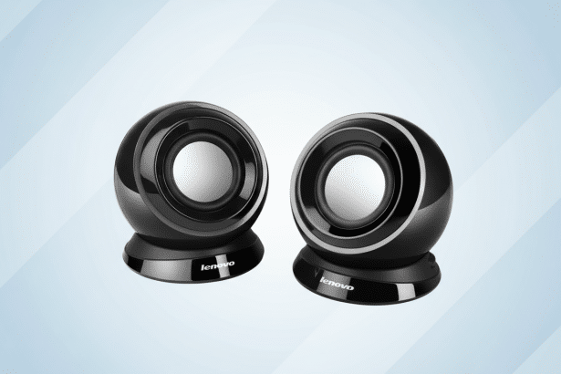 A pair of sleek black Lenovo speakers with silver speaker cones , set against a professional light blue gradient background with subtle horizontal stripe patterns. Filename : lenovo speakersprofessional .png