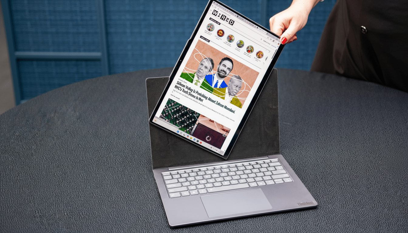 A person s hand adjusting a laptop screen that displays the Wired website, with an article about Silicon Valley and NYCs tech scene.