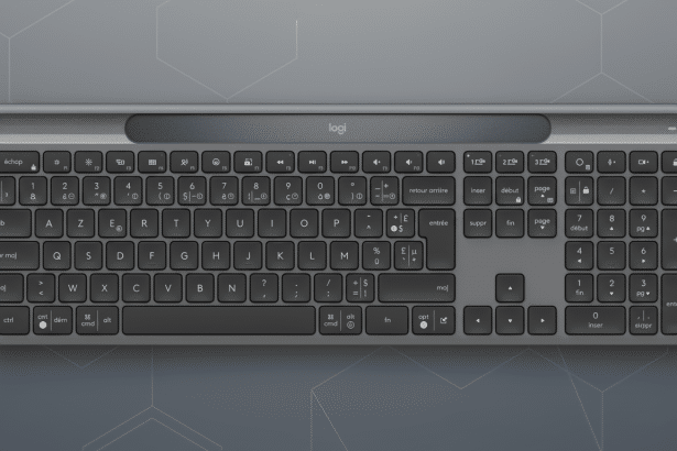 A professional , enhanced image of a dark gray Logitech keyboard with a French layout, presented against a subtle , light gray geometric pattern background.