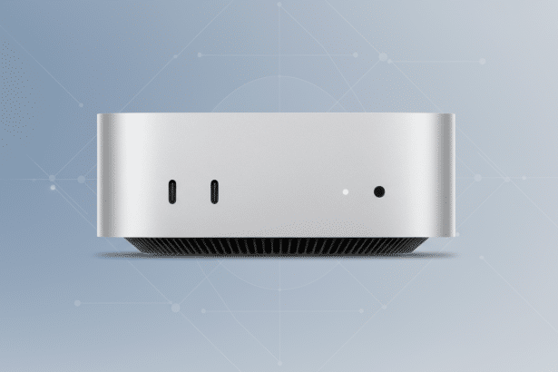 A silver Mac Studio computer , front view , with two USB -C ports, an LED indicator, and a power button, set against a light blue professional flat design background with a subtle geometric pattern. Filename : macstudio frontview professionalbackground .png