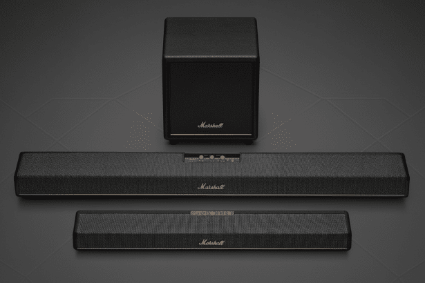A Marshall home cinema speaker set with a subwoofer and two soundbars on a dark background with subtle geometric patterns .