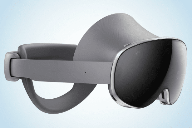** A gray Meta Quest Pro VR headset with a dark visor , shown at an angle, against a soft blue gradient background. **