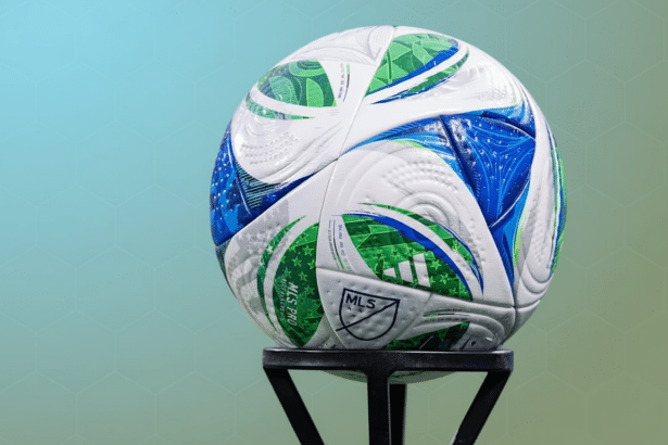 An MLS Pro soccer ball with green and blue patterns on a black stand, set against a professional background with soft blue - green gradients and subtle hexagonal patterns.