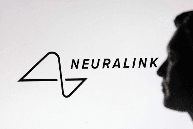A 16: 9 aspect ratio image of the Neuralink logo, a stylized N and L forming a circuit - like design, displayed on a screen with the silhouette of a p