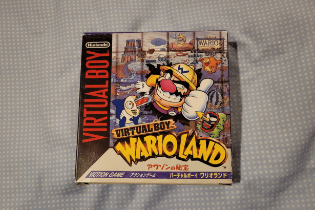 The box art for the Virtual Boy game Wario Land, featuring W ario giving a thumbs up and surrounded by various enemies and characters from the game.