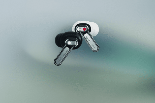 Two Nothing Ear ( 1) earbuds, one black and one white, on a subtle gradient background.