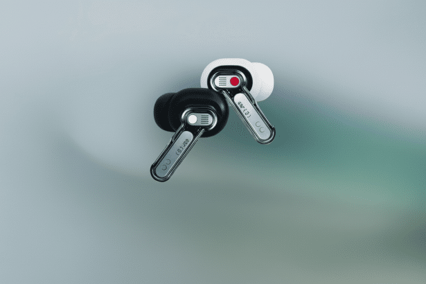 Two Nothing Ear ( 1) earbuds, one black and one white, on a subtle gradient background.