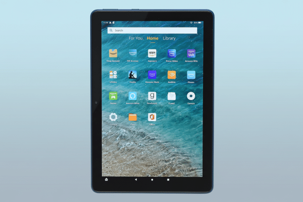 An Amazon Fire tablet displaying its home screen with various apps on a light blue gradient background.