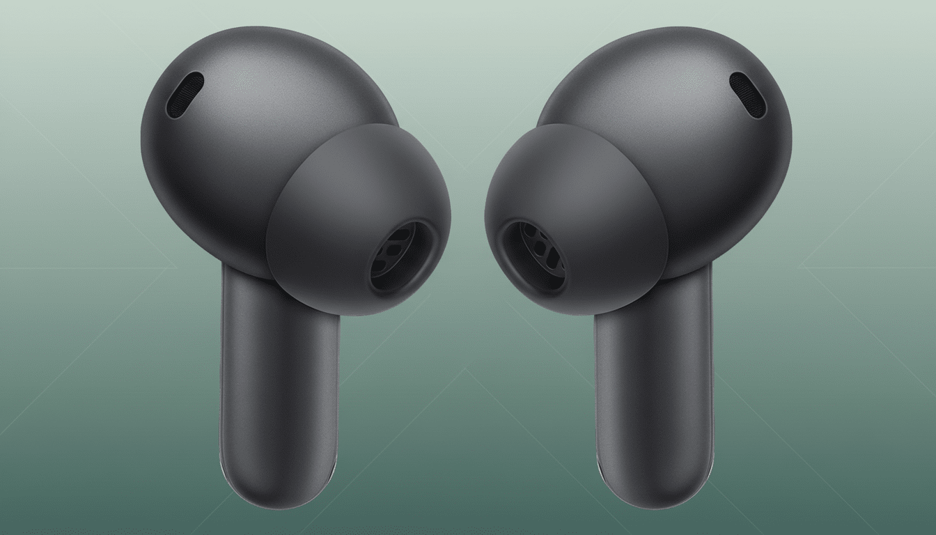 A pair of dark grey wireless earbuds with soft, textured ear tips, presented on a subtle green gradient background.