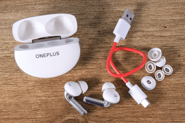 OnePlus earbuds, charging case, USB cable, and ear tips displayed on a wooden surface.