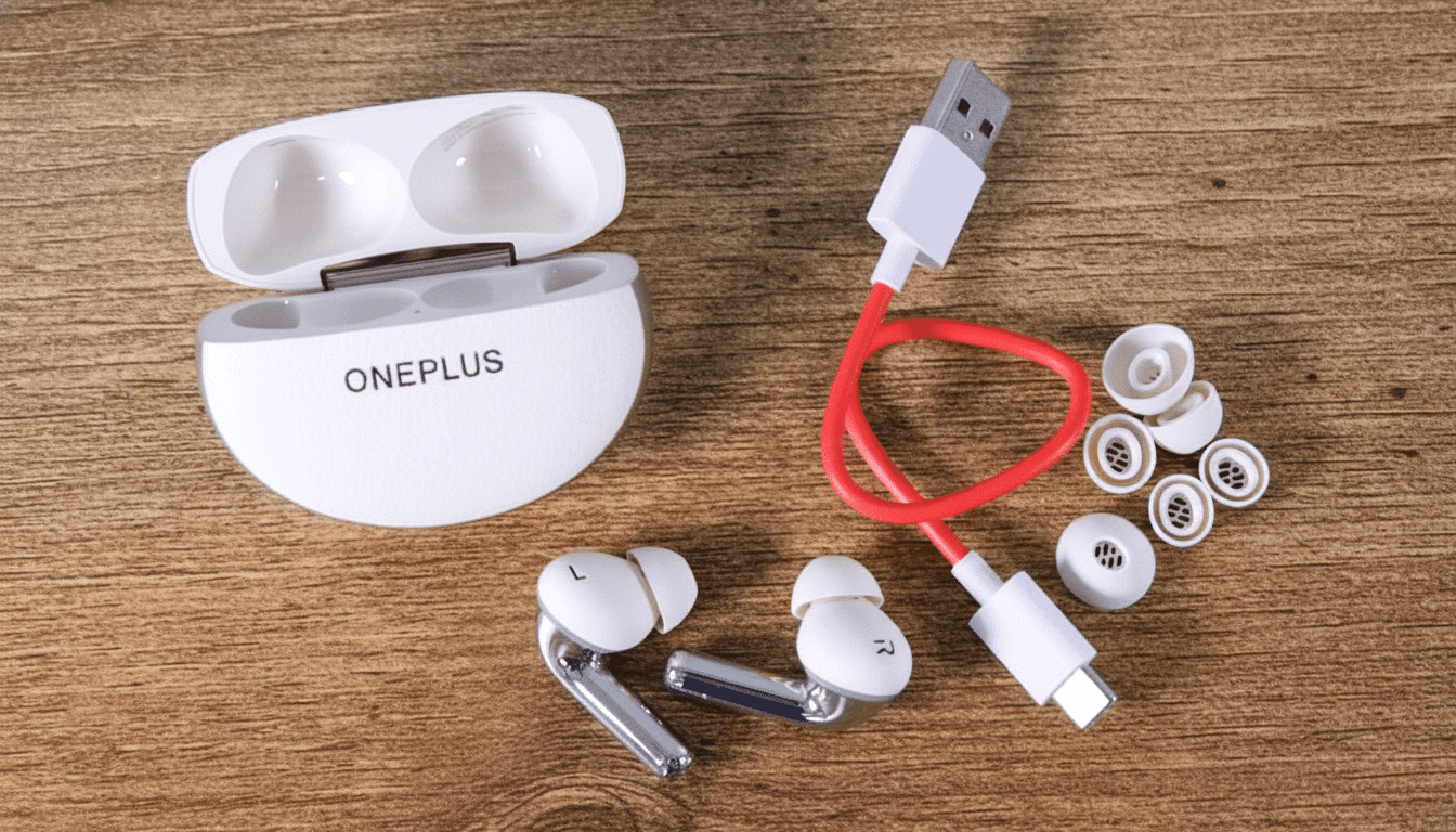 OnePlus earbuds, charging case, USB cable, and ear tips displayed on a wooden surface.