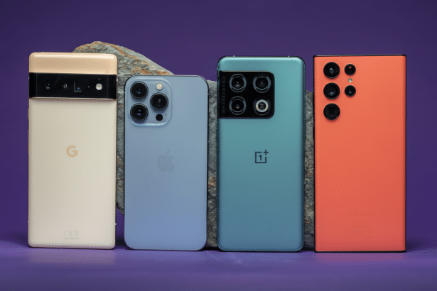 Four different smartphone models, including a Google Pixel, an iPhone, a OnePlus, and a Samsung, are lined up horizontally with their backs facing the viewer . They are placed against a purple background with a rock accent behind them. Filename : foursmart phones16 9. png
