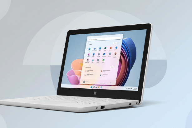 A white laptop with a dark screen displaying the Windows 11 interface, placed on a light blue background with a subtle semic ircular pattern.