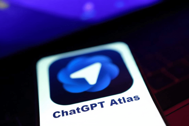 Close -up of a smartphone screen displaying the ChatGPT Atlas app with a blue , abstract logo resembling a paper airplane. Filename : chatgpt atlasapp. png