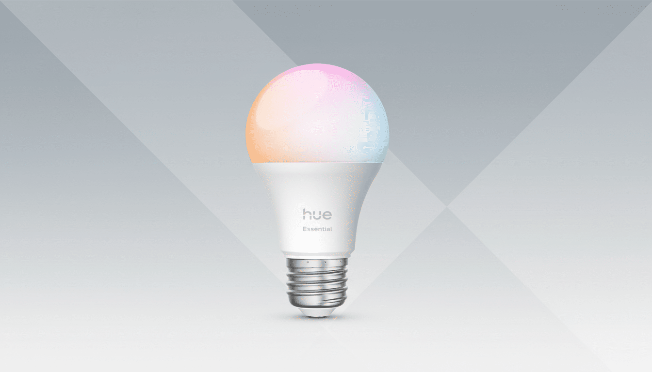 A professional 16:9 aspect ratio image of a Philips Hue Essential smart light bulb with a gradient of pastel colors on the bulb , set against a clean grey background with subtle geometric patterns. Filename : phil ipshue essentialsmart bulb1 69. png