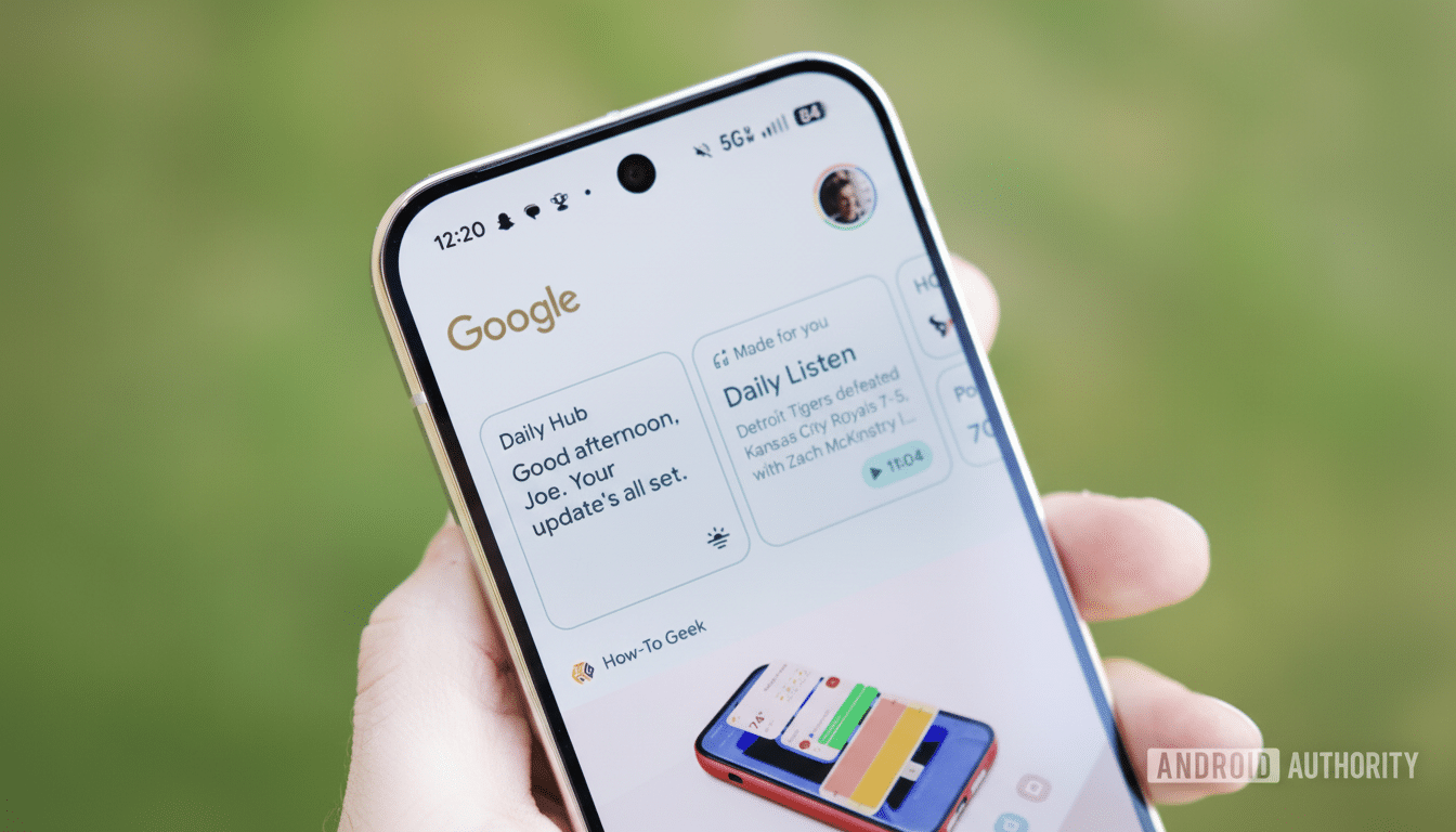 A hand holding a smartphone displaying the Google app with news updates and a user profile picture.