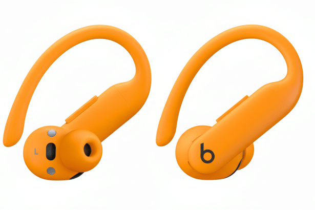 Two orange wireless earbuds, the left one showing the e arpiece and L indicator, the right one showing the b logo, both set against a clean white back