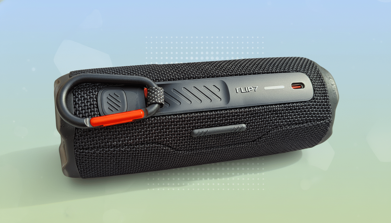 A black JBL Flip 7 portable speaker with a black and orange carabiner clip attached, set against a professional soft gradient background with subtle p