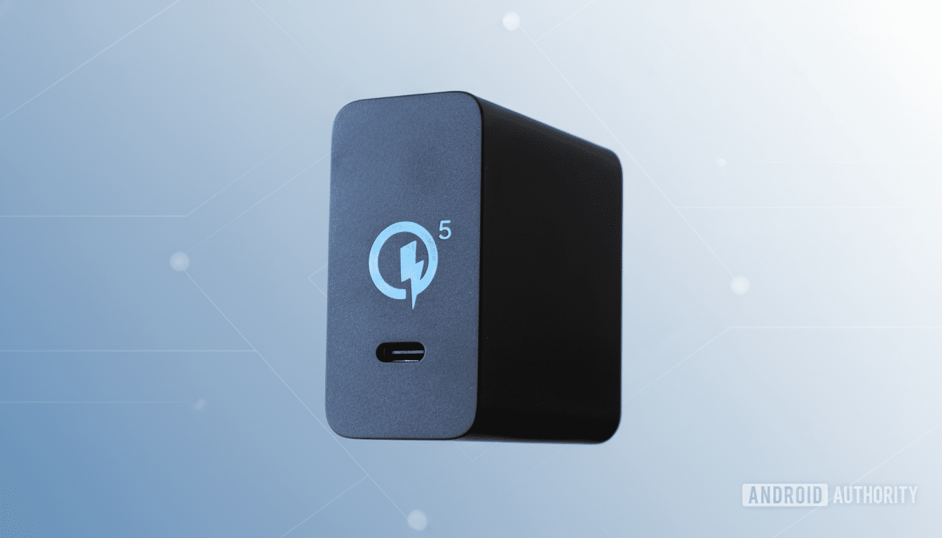 A black rectangular power adapter with a light blue Quick Charge 5 logo and a USB- C port, set against a professional soft blue gradient background wi