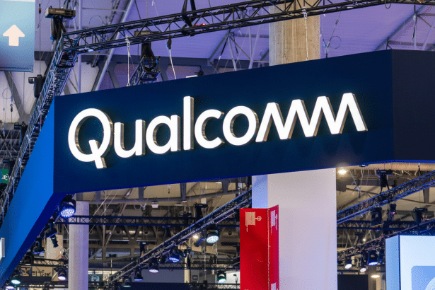 The Qualcomm logo displayed on a large, illuminated sign at a professional event or trade show.