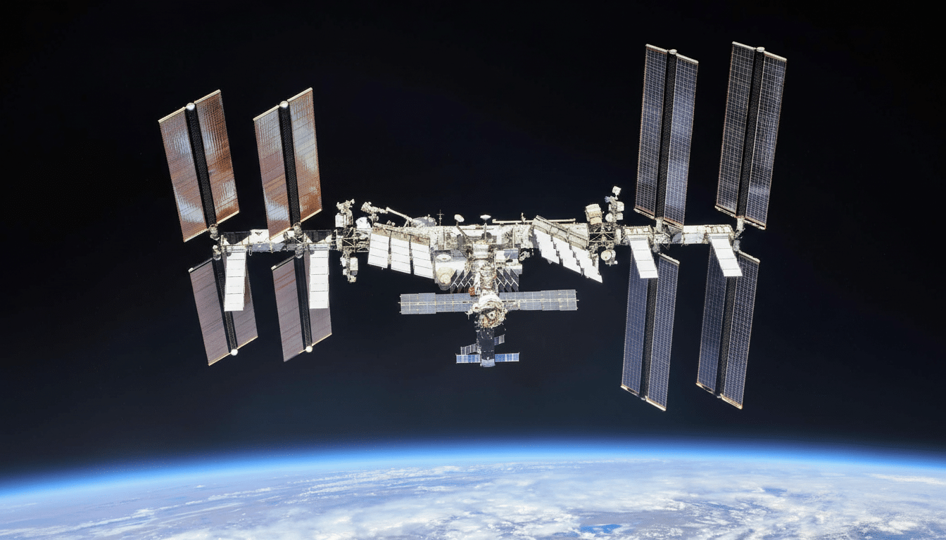 The International Space Station ( ISS) orbits above Earth, with its solar arrays extended against the dark expanse of space and the blue curve of the