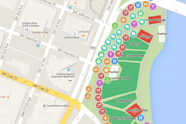 A map showing a riverfront park area with various amenities and stages marked with icons, alongside city streets and buildings.