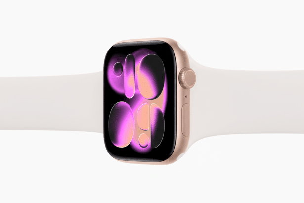 A rose gold Apple Watch with a white band, displaying a colorful, abstract watch face, set against a clean white background.