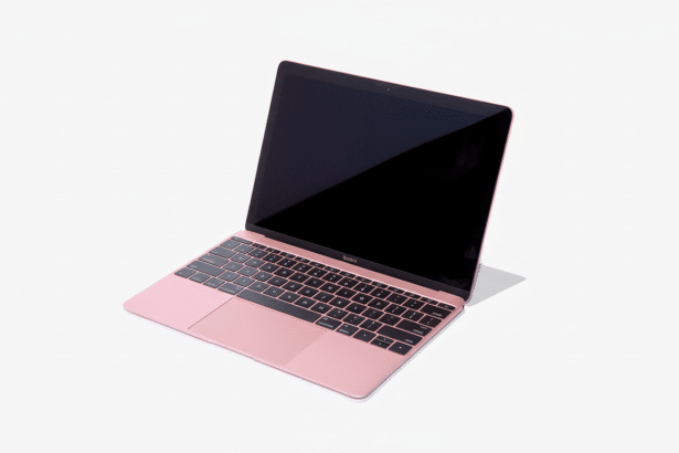 A rose gold MacBook laptop with a black screen and keyboard, viewed from an angle against a white background.