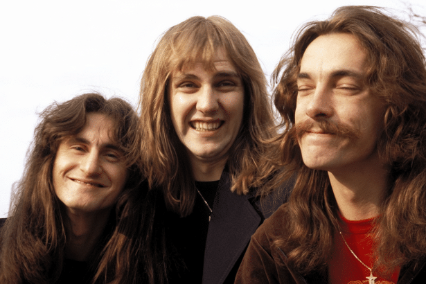 A professional, enhanced image of the rock band Rush ( G eddy Lee, Alex Lifeson, and Neil Pe art) with their original background, resized to a 16: 9 a