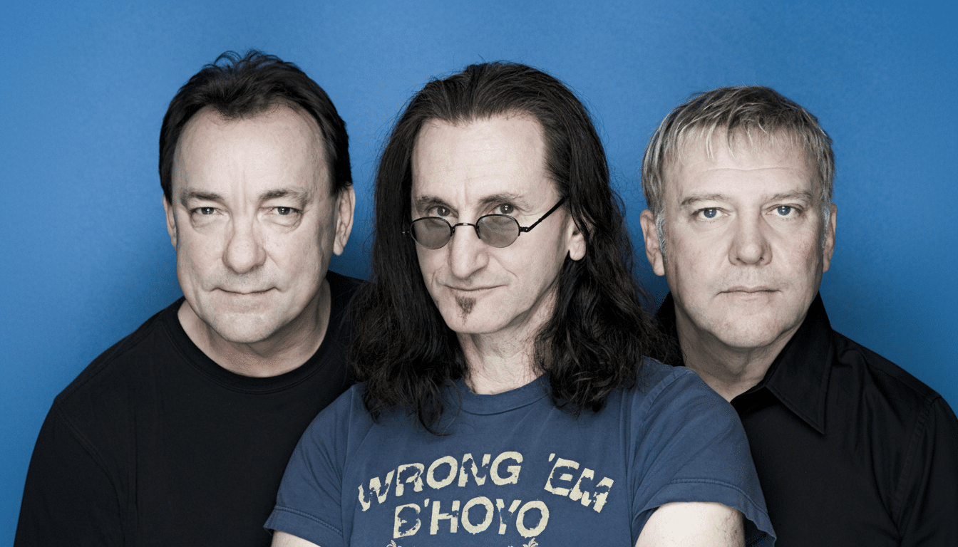 A professional head shot of the three members of the band Rush, with Ged dy Lee in the center wearing sunglasses and a blue t- shirt, flanked by Alex