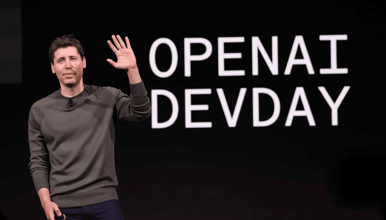Sam Altman on stage at OpenAI Dev Day, waving to the audience in front of a large screen displaying the event logo.