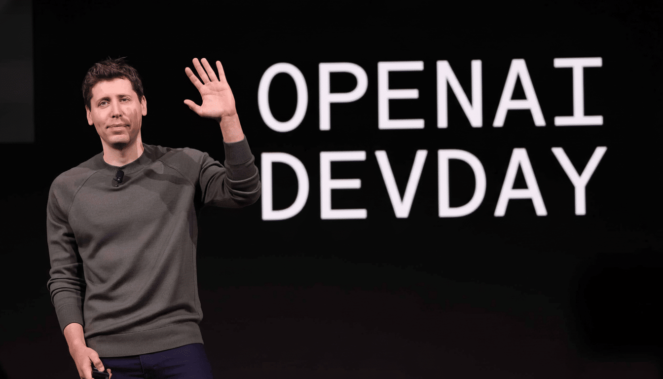 Sam Altman waving on stage at OpenAI Dev Day.