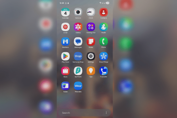 A smartphone screen displaying a grid of various app icons, including Calendar , Camera, Clock , Contacts, Email , Gallery, Gaming Hub, Health, Members, Messages, Notes, Phone, Play Store, Samsung Shop, Settings, SmartThings, Store , Surfshark, Tips, Truecaller , Wallet, and Wear. A search bar is visible at the bottom.