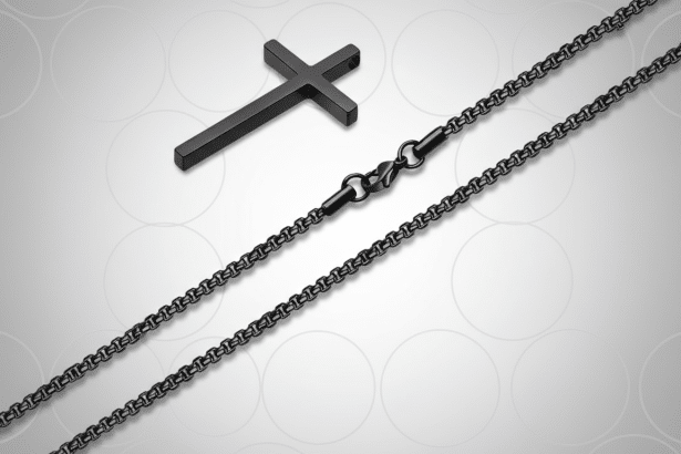 Professional studio shot of a black stainless steel chain with a cross pendant and clasp, presented on a subtle grey patterned background. Filename : blackcross chainprofessional . png