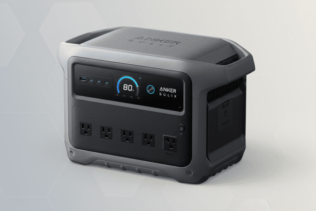 Anker Solix portable power station on a professional light grey background with subtle hexagonal patterns.