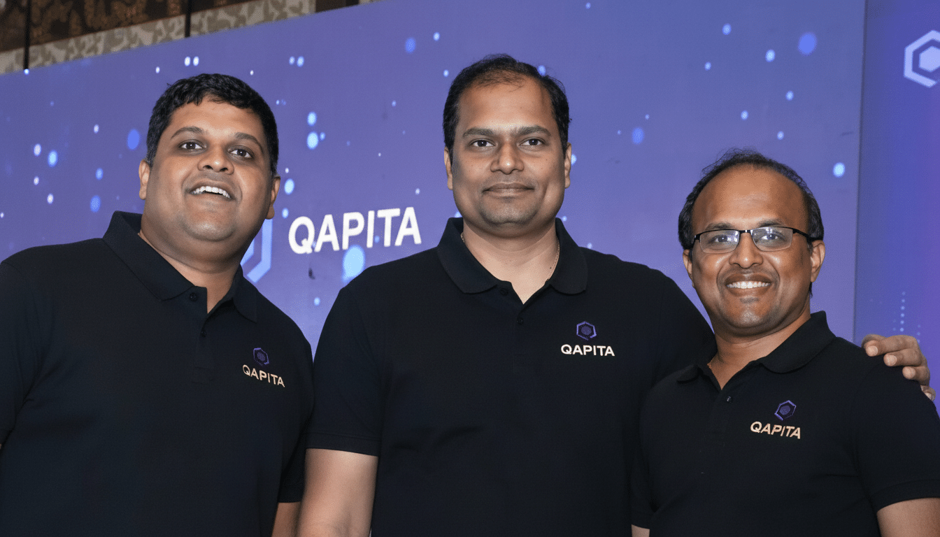 Three men wearing black Qap ita polo shirts stand in front of a blue background with the Q apita logo.