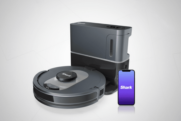 A Shark brand robot vacuum, its charging station, and a smartphone displaying the Shark logo on a purple screen are arranged on a professional light gray background with subtle geometric patterns .